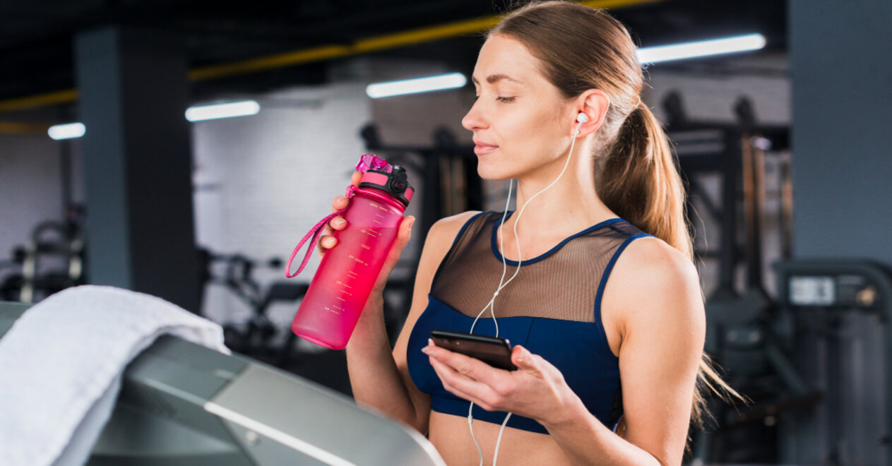 woman using smartphone gym 1